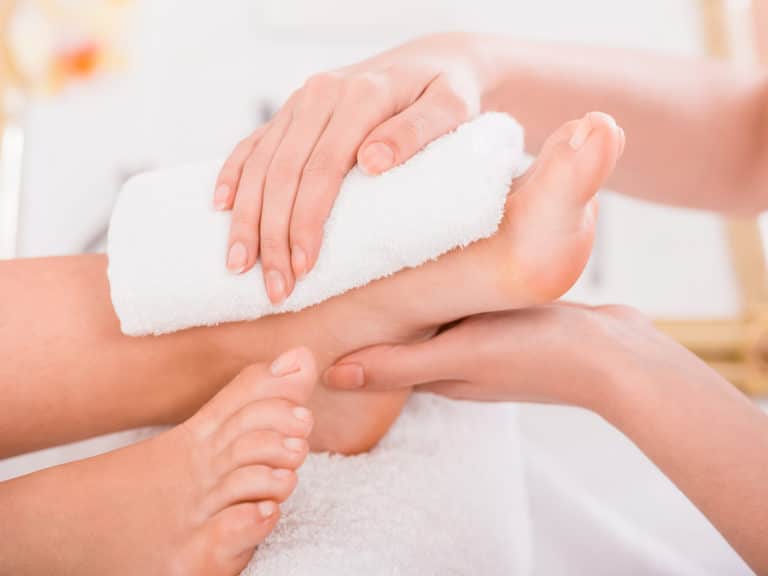 Close-up of relaxation pedicure process in spa salon.